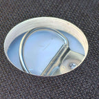 Un trou sur le plancher Edelclick, pour accéder à la boucle d'arrimage fixée à la carrosserie du véhicule utilitaire.